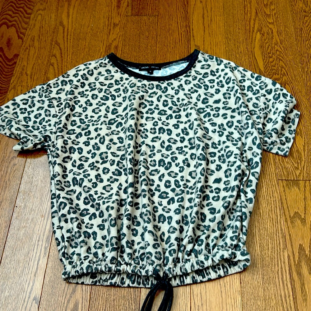 This shirt is a Cheetah print shirt with a scrunch on the bottom of it